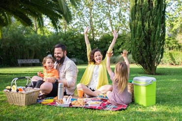A family having a picnic in a local park.