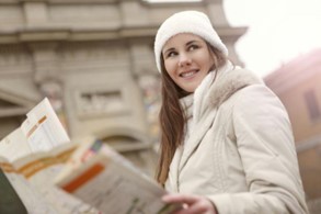 Take your time to prepare for a safe and informed relocation planning. Person holding a map in an urban setting.