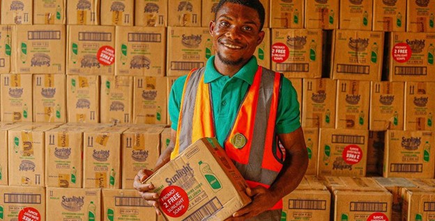 A man holding a box in a storage room
